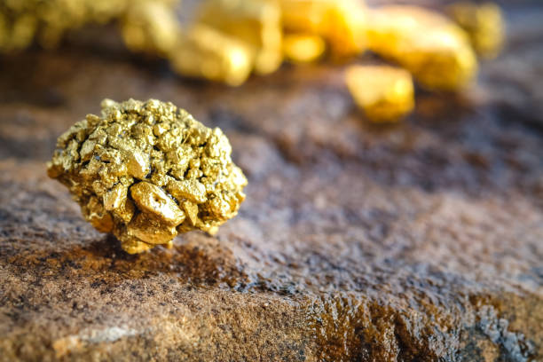 istock The pure gold ore found in the mine on a stone floor 929521232