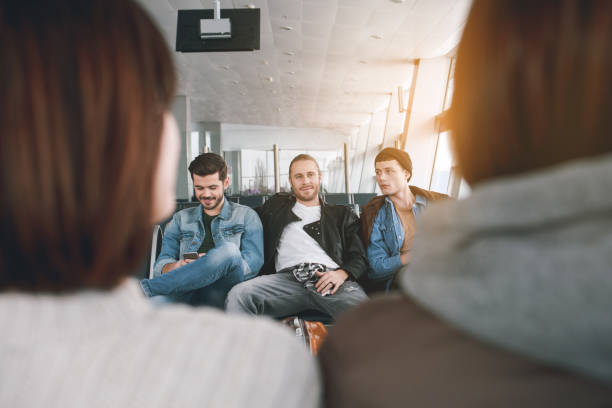 istock Cheerful comrades waiting for plane in airport 929528594