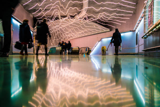 Stockholm, Sweden - December 19, 2017: New train station Stockholm City. Commuters in escalators. Light reflected in floor.