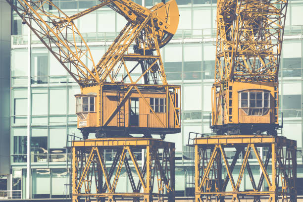 Old cranes in Puerto Madero Waterfront district. Modern skyline at sunny day.