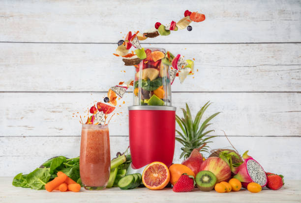 istock Smoothie maker mixer with fruit and vegetable flying ingredients 929545368
