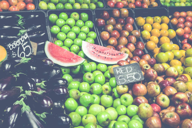 Market stall with tropical fruits and vegetables.