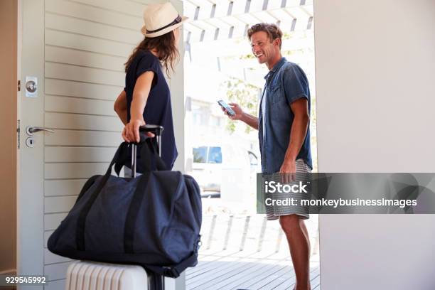 Couple Using Online App To Book Cab For Vacation Stock Photo - Download Image Now - Leaving, Domestic Life, Home Interior