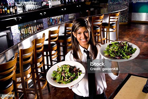 Smiling Hispanic Waitress Serving Salads Stock Photo - Download Image Now - One Woman Only, Restaurant, Service