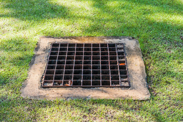 istock Old iron drain hatch on the lawn. 929552070