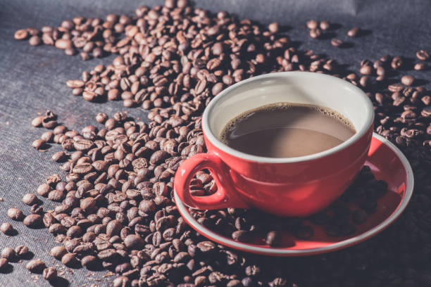 istock coffee in red cup and coffee beans are the background. 929552396