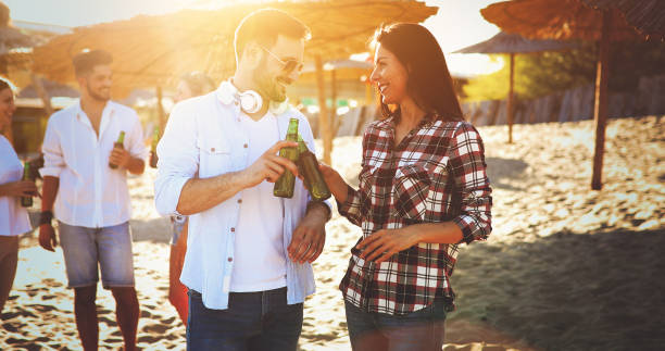 istock Happy group of young people having fun on beach 929554968