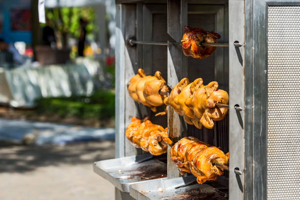 Roasted chickens in a row in a shop roaster. Roasted chickens in a row in a shop roaster. smoking meat rotisserie barbecue grill stock pictures, royalty-free photos & images