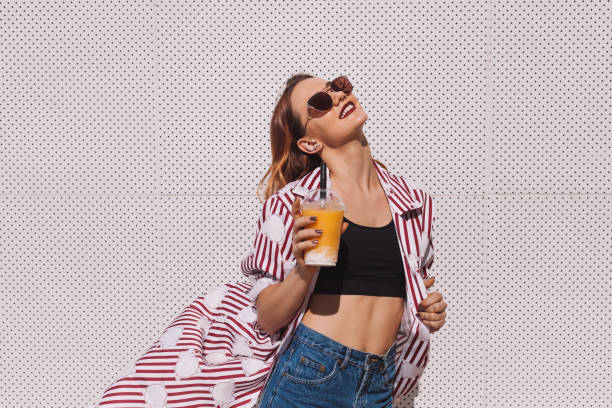 istock sensual young woman with mango shake in plastic cup 929555634