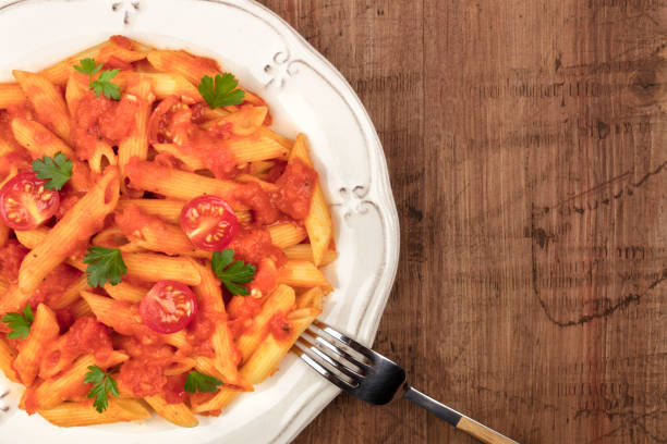 istock Penne pasta closeup with tomato sauce and place for text 929555772