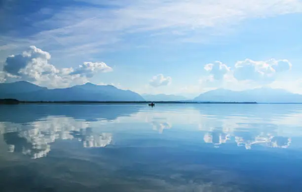 Fishing boat with fisherman at Lake Chiemsee, Upper Bavaria, Germany