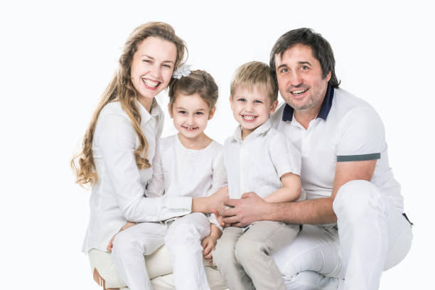 istock family portrait: parents with daughter and son on white background 929559778