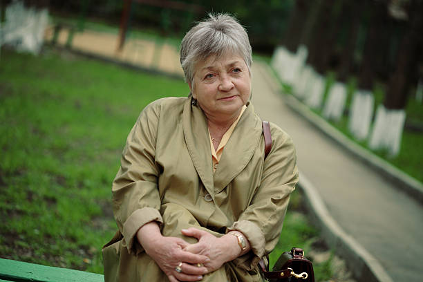 istock aged woman sitting in park 92956052