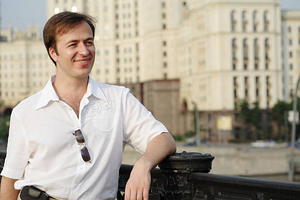 istock happy smiling young man in city 92956295