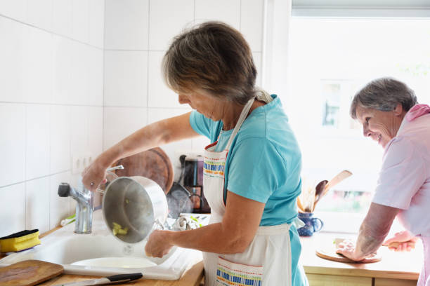 istock senior women cooking together in kitchen 929564766