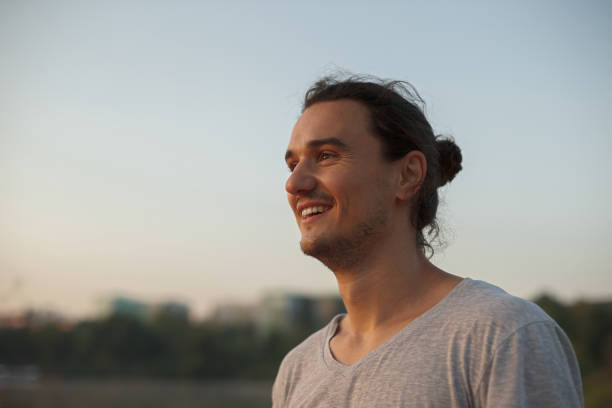 istock Handsome man smiling in the park 929565568