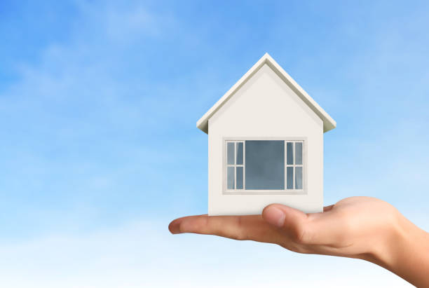 istock Mortgage concept by house from  hand 929569030
