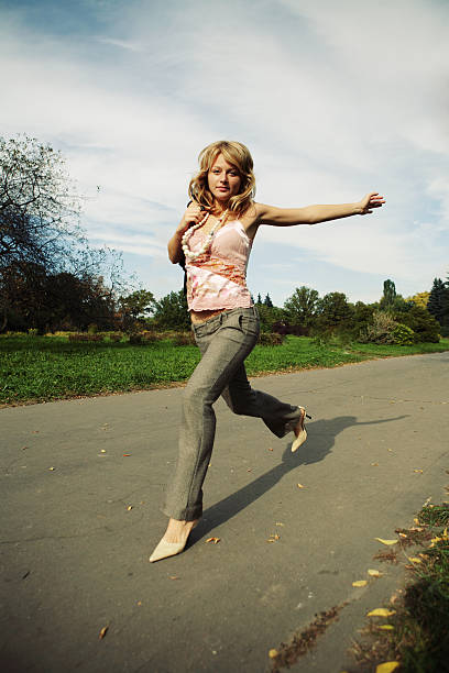 istock Attractive blonde woman walking in park 92956971