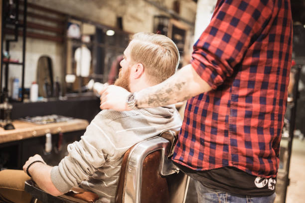 istock Ginger, bearded guy at the barber shop. Barber-Client Consultation 929581558