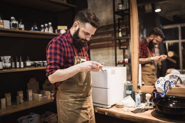istock Handsome, hipster barber at his barber shop, working 929581638