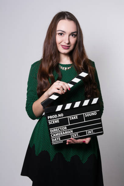 istock Young woman holding a movie clapper 929581930