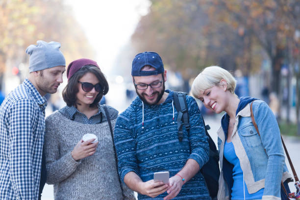 Young people hanging on street and taking selfie