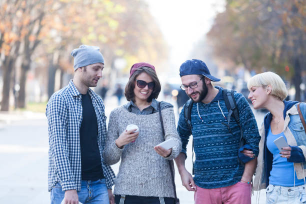 istock Young people walking on street and taking selfie 929584204