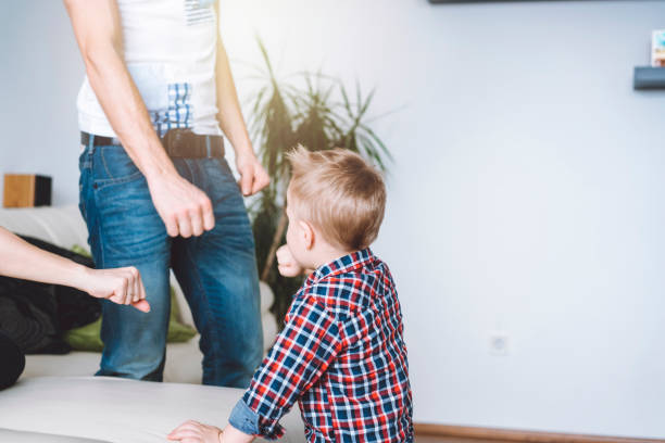 istock Cute little boy playing with his parents 929584384