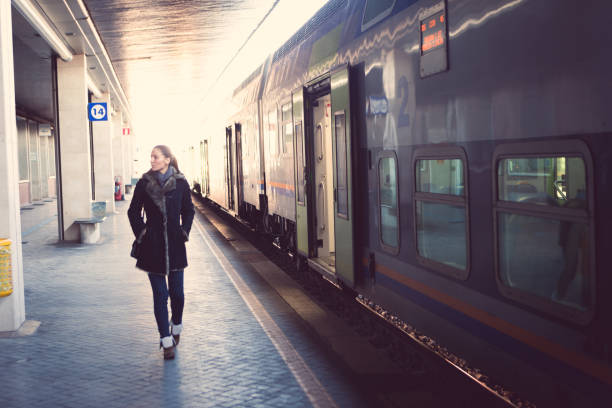 istock Woman walking on train station platform 929584868
