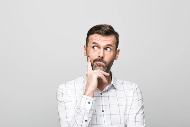 istock Portrait of worried, handsome man, grey background 929584944