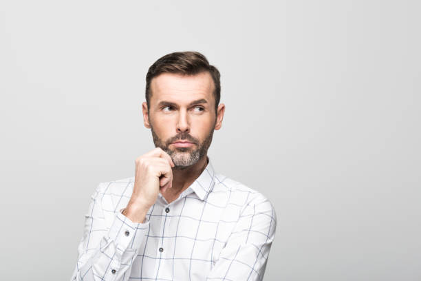 istock Portrait of pensive, handsome businessman, grey background 929585122