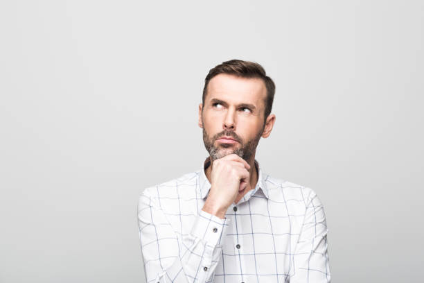 istock Portrait of pensive, handsome man, grey background 929592028