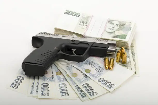 Photo of gun and czech banknotes, crime concept