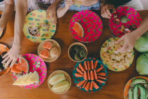 istock Family eats  tropical fruits on patio 929605844