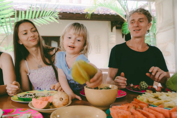 istock Family eats  tropical fruits on patio 929605998