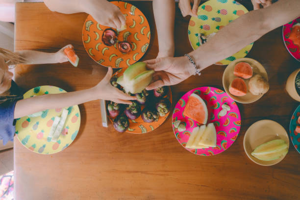 istock Family eats  tropical fruits on patio 929606086