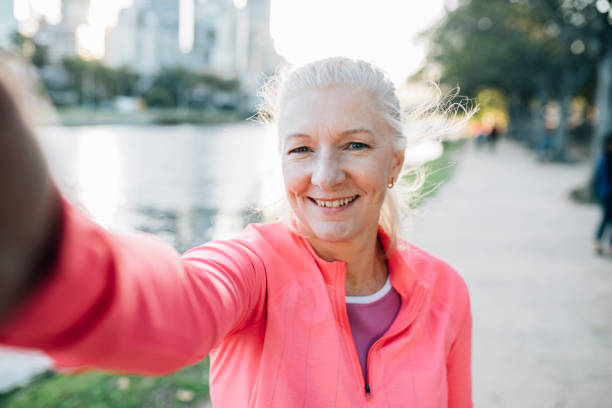 istock Happy senior female runner takes a selfie 929606658