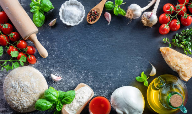 istock Pizza Preparation With Ingredients dough On Black Table - Italian Food 929609004