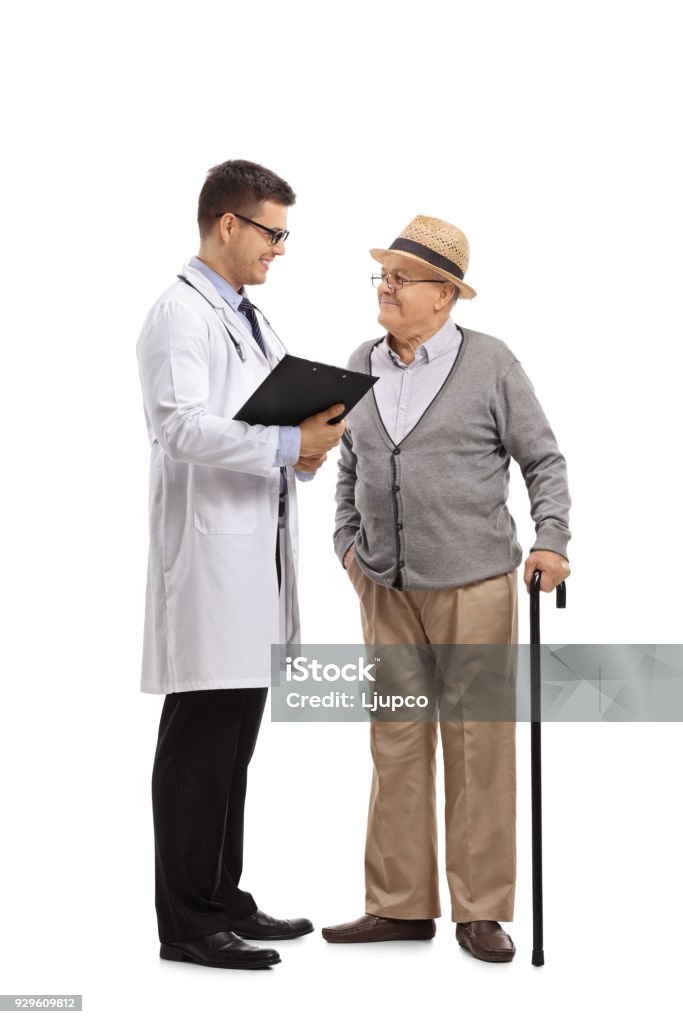 Doctor talking to an elderly patient Full length profile shot of a doctor talking to an elderly patient isolated on white background Doctor Stock Photo