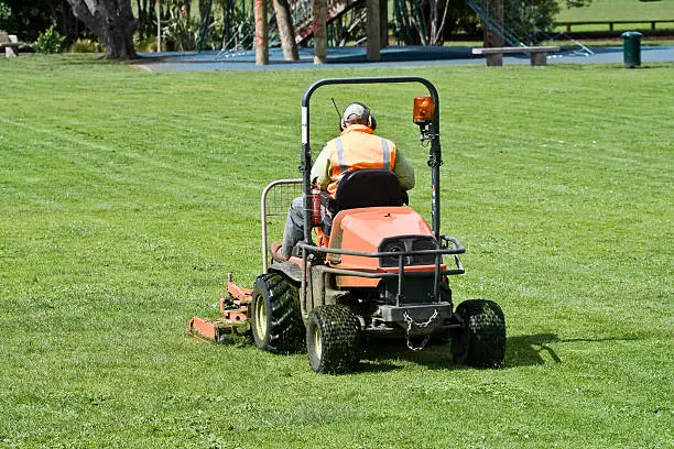 Photo of Man on Ride-On mower cutting grass