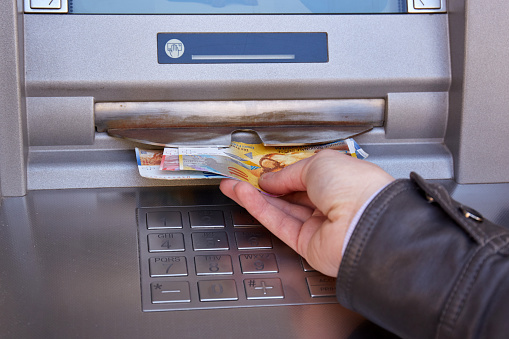 woman hand take out swiss franc banknotes