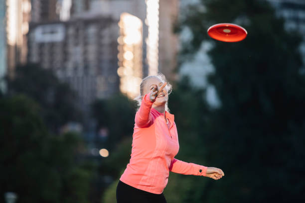 istock Active senior woman throwing frisbee 929624484