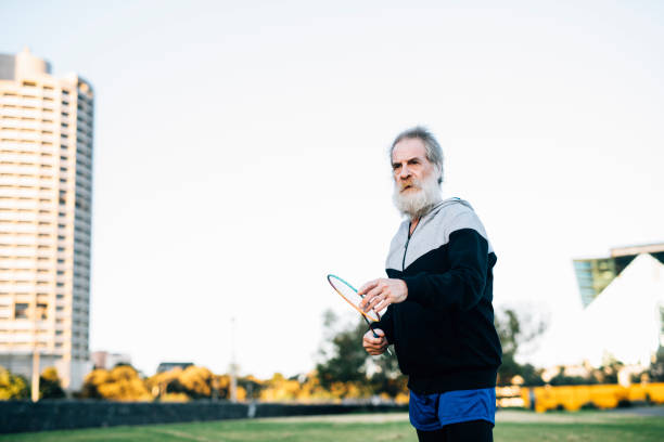 istock Active senior man concentrates during badminton match 929624504