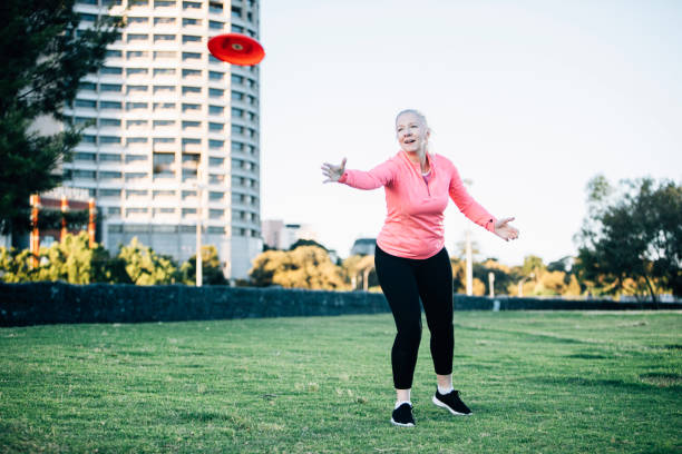 istock Active senior lady throwing frisbee 929624516