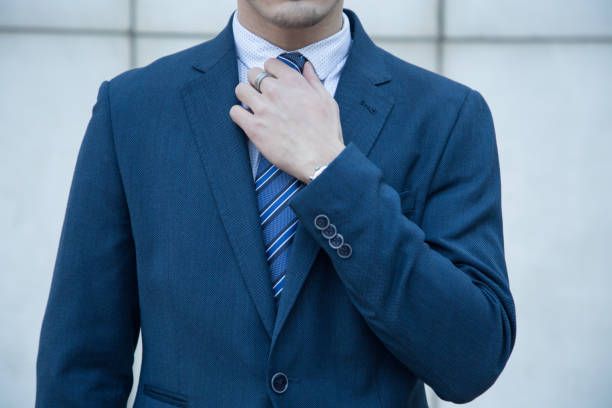 istock Young business manin suit on a white background 929628480