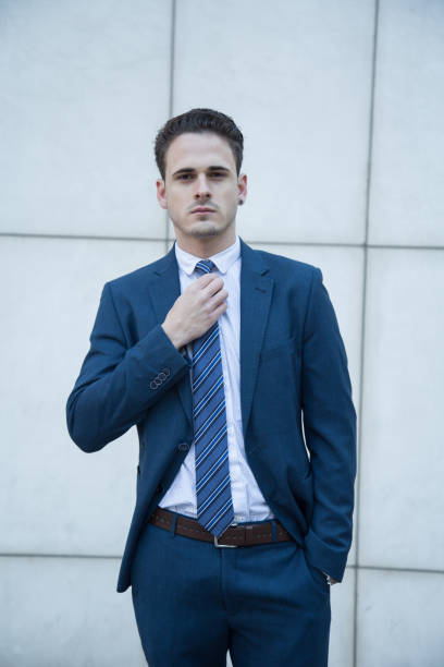 istock Young business manin suit on a white background 929628490