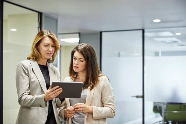 istock Businesswomen discussing over digital tablet