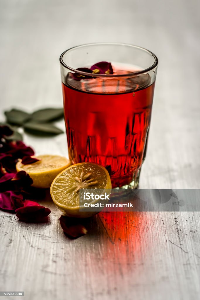 Rosa,rose juice with ice cubes and lemon,Citrus Ã limon and some rose petals. Backgrounds Stock Photo