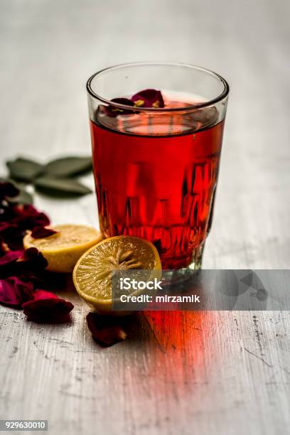 Rosa Rose Juice With Ice Cubes And Lemon Citrus Ã Limon And Some Rose Petals Stock Photo - Download Image Now