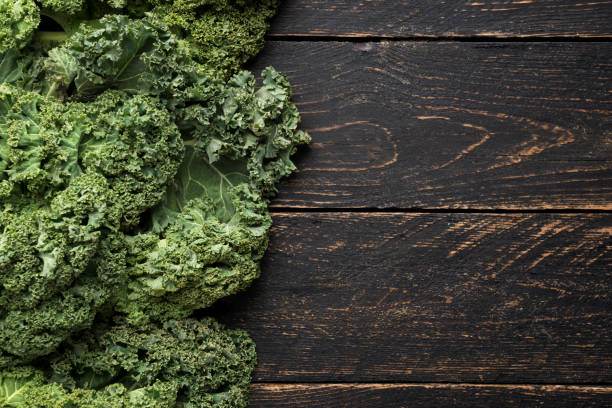 istock Bunch of kale on a wooden background 929640582